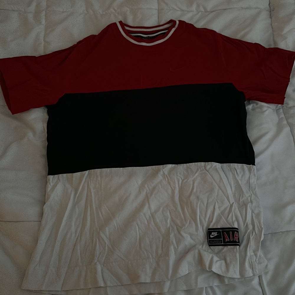Red, black, and white Nike shirt.